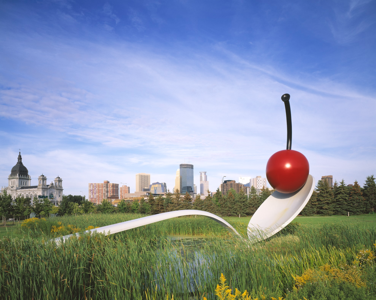A view of a giant spoon with a cherry perched on the end