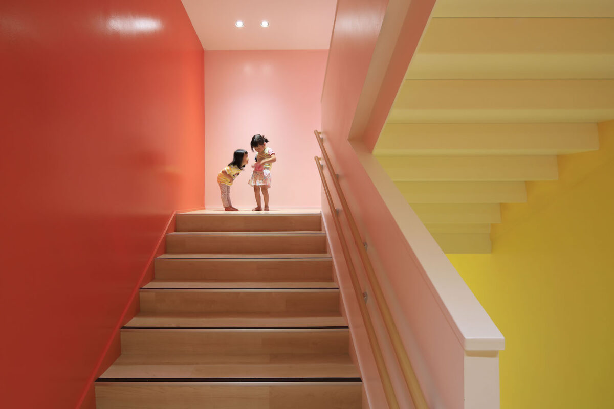 A colorblocked hallway featuring pink, yellow, and red.