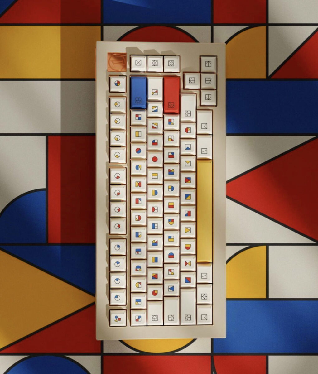 A computer keyboard with colorful shapes representing the letters, in primary colors. 