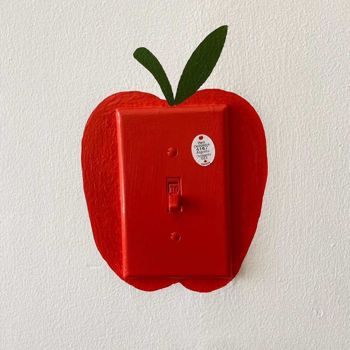 Red apple painted over light switch | How to Add Pops of Color to Your Home on a Budget