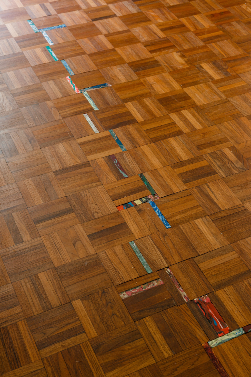 Wood flooring with pops of color in between made from Sculpey.