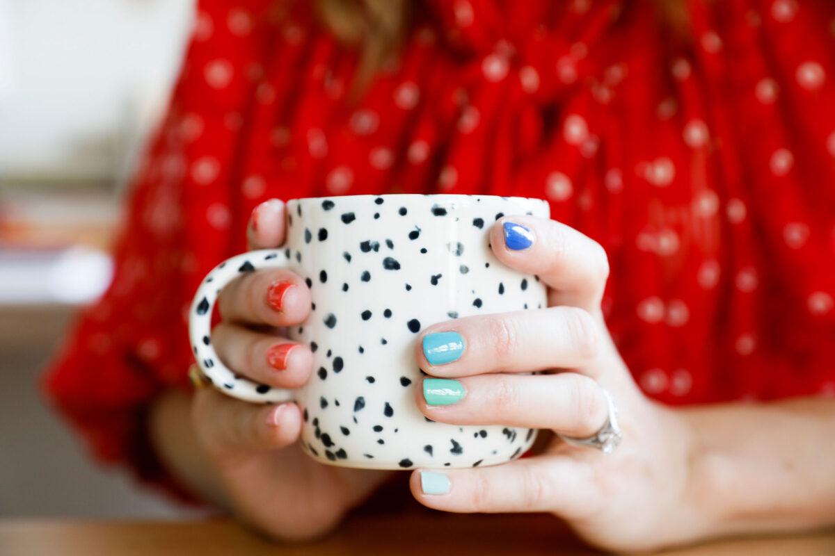 Multicolor nails on a spotted cup