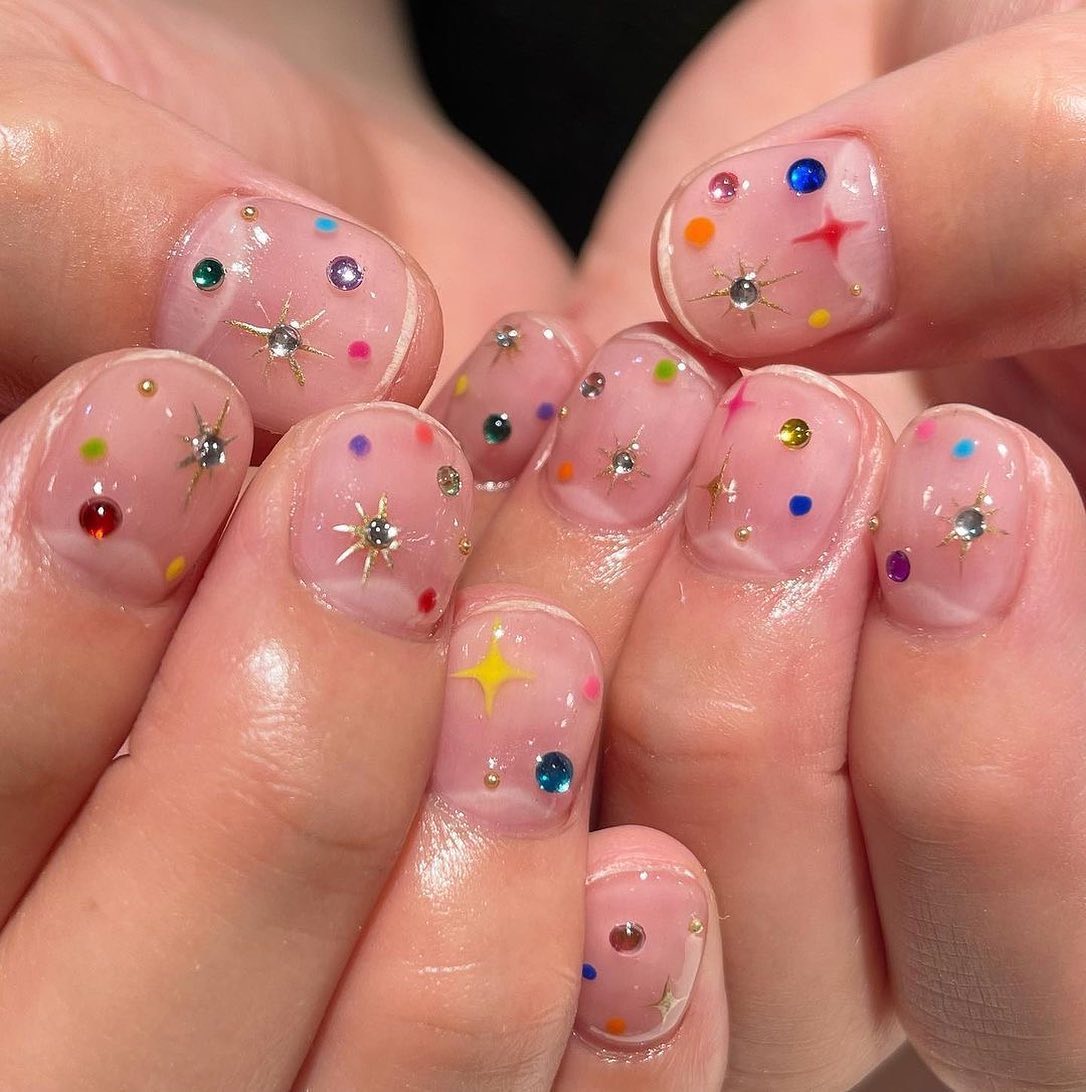 Manicure with colorful dots and gemstones
