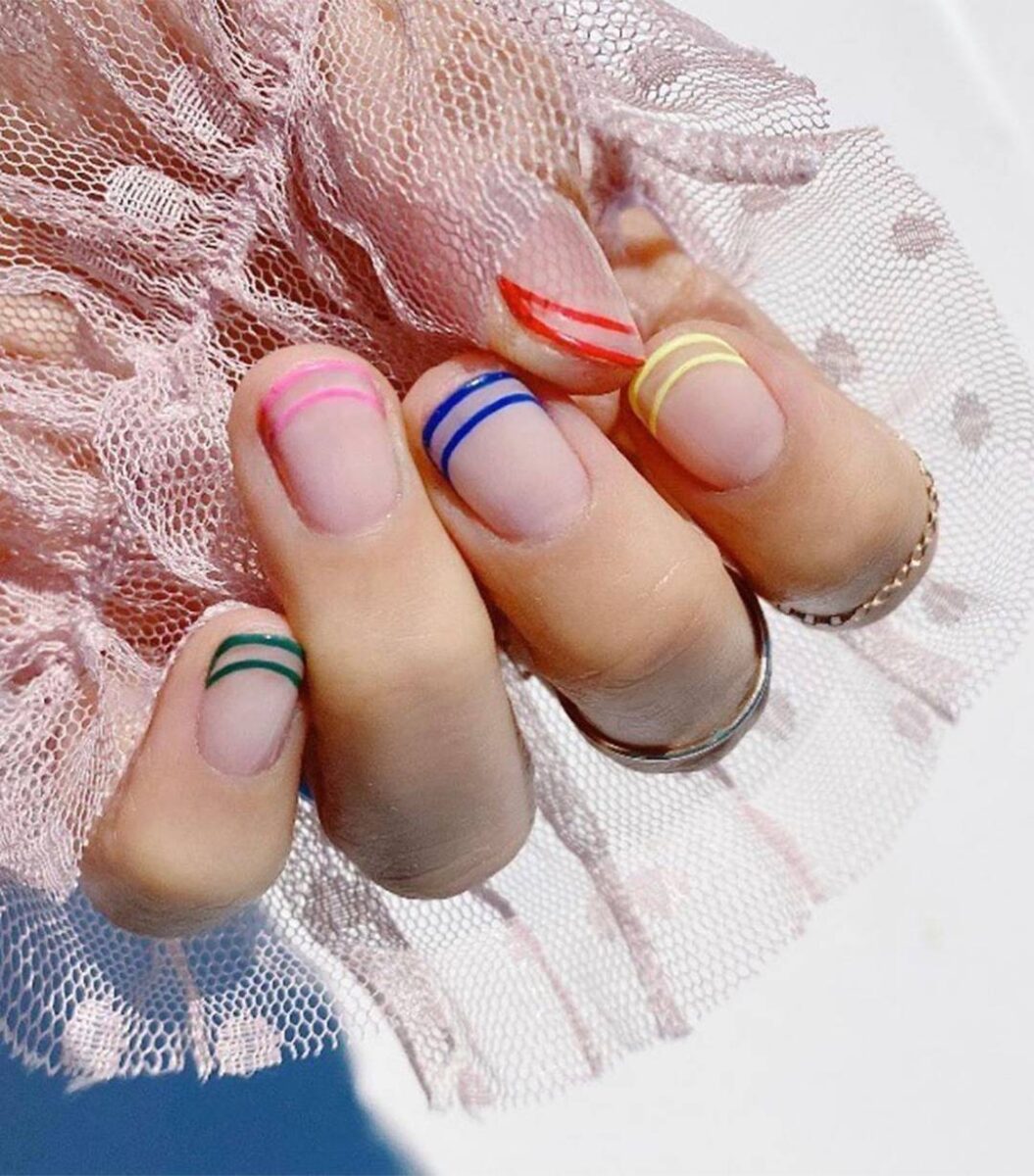 Nails with two thin lines of a different color at the top of each nail