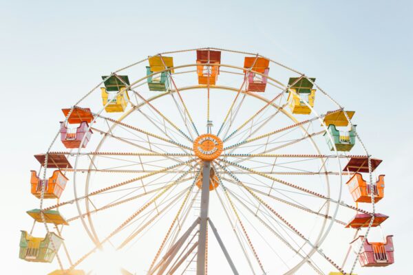 A ferris wheel viewed from below looking up toward the sky